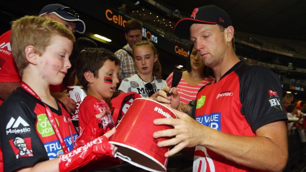 Cameron White of the Renegades signs his autograph during a BBL game last at Etihad last year.