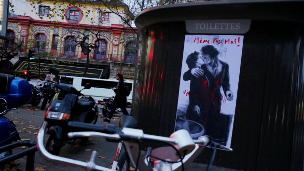 A poster of wounded lovers stating "Not even hurt" opposite the Bataclan concert hall.