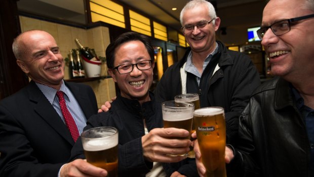 Matthew Ng celebrates his release with his lawyer, Tom Lennox (left) and friends from his days studying at the Australian Graduate School of Management, David Marquard and Ken Wagner. 