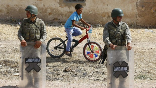 Turkish soldiers at the border gate near the Syrian town of Kobane, a key battleground between Kurdish militias and the forces of Islamic State.