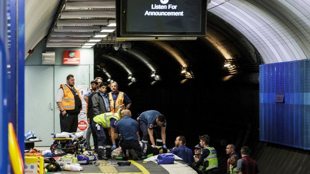 A woman is rescued by paramedics after falling onto the train tracks at Parliament Station.