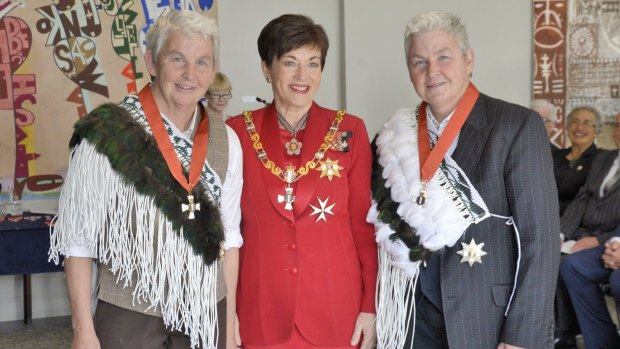 The New Zealand Governor-General Dame Patsy Reddy at the investiture of the Topp Twins - on the left, Dame Jools Topp, on the right, Dame Lynda Topp.