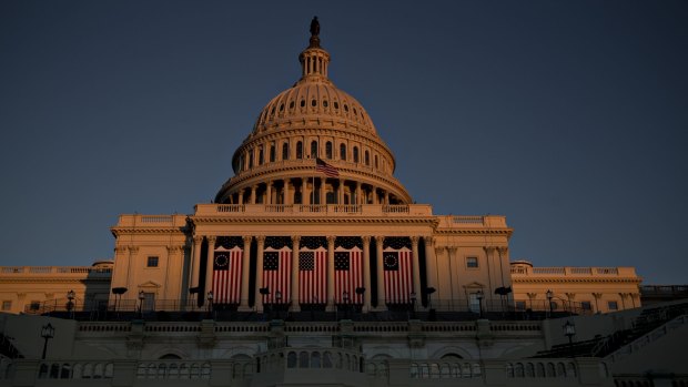 American flags hang outside the US Capitol in Washington, DC, in preparation for Donald Trump's inauguration.