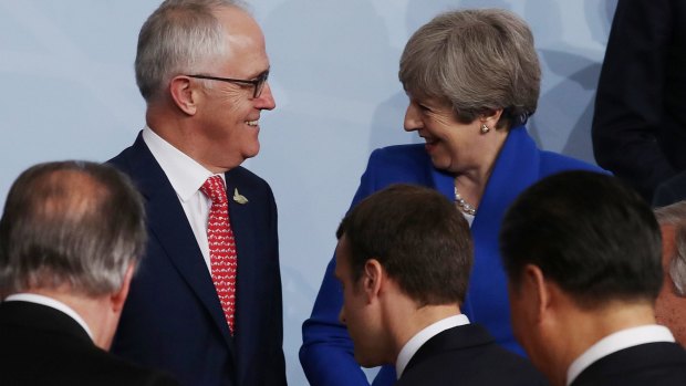 Australian Prime Minister Malcolm Turnbull and Theresa May talks during the family photo at the G20 Summit in Hamburg.