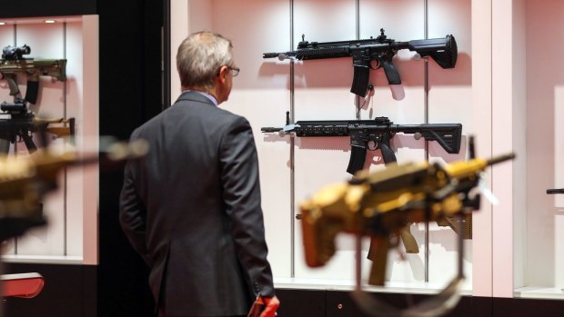 An attendee looks at a display of Heckler & Koch submachine guns at an arms fair in London last week.