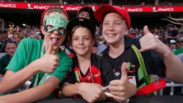 All smiles: Young fans getting ready for the big clash. 