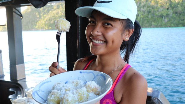 Ega, one of the crew, offering us a post-paddling snack of coconut balls.