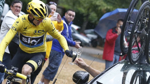 Chris Froome toasts his win en route to Paris.