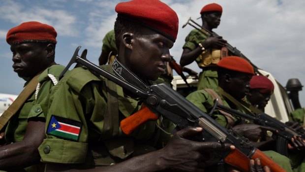 Rebel soldiers provide security for their chief of staff, Simon Gatwech Dual, as he returns to the capital Juba after the South Sudan peace agreement.