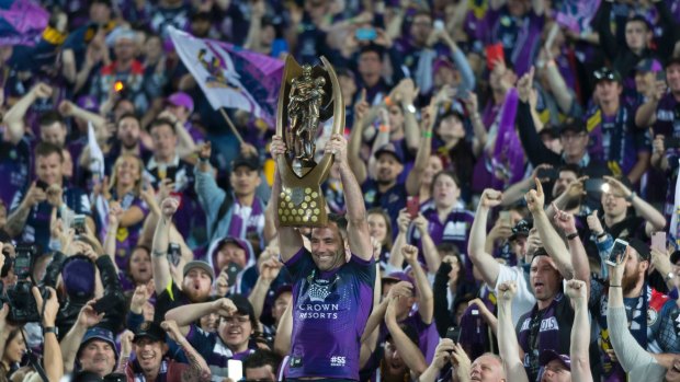 Winner takes all: Cameron Smith holds the NRL trophy aloft after the Storm's victory in October.