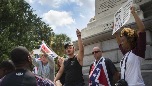 Pro-confederate flag demonstrators argue with anti-confederate flag protesters outside the South Carolina State House.