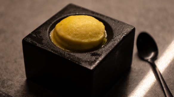 Mandarin sorbet served in a block of granite.