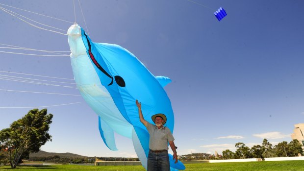Kite flyer, Ian Burrell of Gowrie takes advantage of the windy conditions in Canberra.