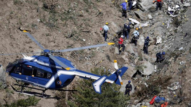 French investigators work through the debris of the crash in the French Alps.