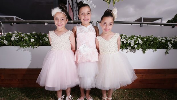 The Silvestro sisters, Alessia, 6, Allira, 8, and Allegra, 6, at the junior girls' Fashions on the Field on Stakes Day.