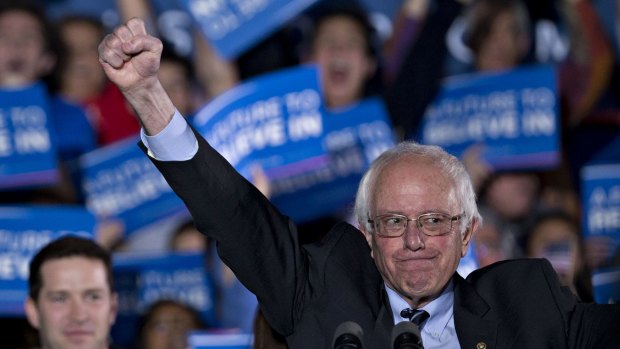 A triumphant Bernie Sanders greets his supporters at Concord High School in New Hampshire on Tuesday.