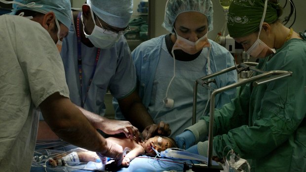 Doctors at the Royal Childrens Hospital, Randwick, Sydney, prepare a baby for heart surgery in 2006.