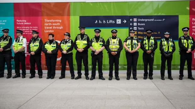 Police officers line up at London Bridge station on Tuesday to observe a minute's silence for the victims of the June 3 terror attacks.