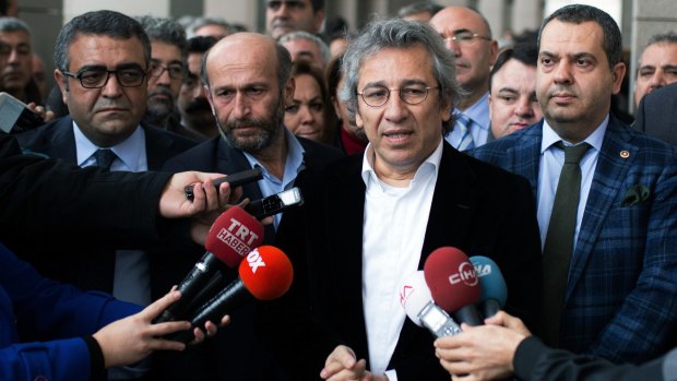 Can Dundar, the editor-in-chief of the Cumhuriyet newspaper, speaks to the media. The paper's Ankara bureau chief, Erdem Gul, is pictured to his left. The two men face jail for reporting on Turkish politics and security issues.