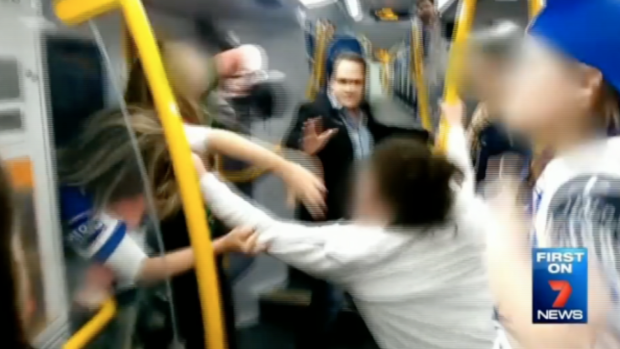 A male passenger tries to stop a brawl between teenage girls on a Sydney train.