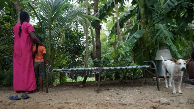 Asha* and her daughter in the garden in southern India. She is determined not to give in.