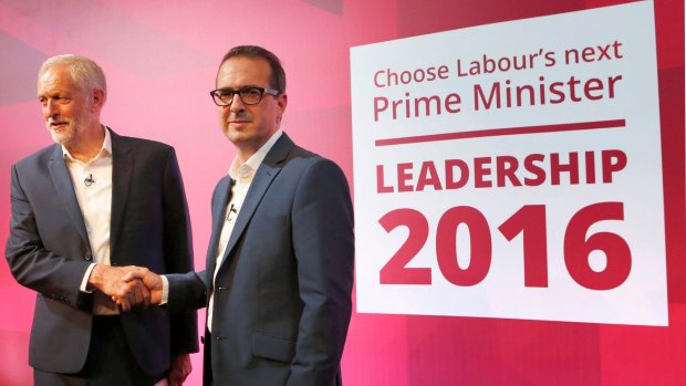 Leadership contender for Britain's Labour Party Owen Smith, right, shakes hands with current leader Jeremy Corbyn.