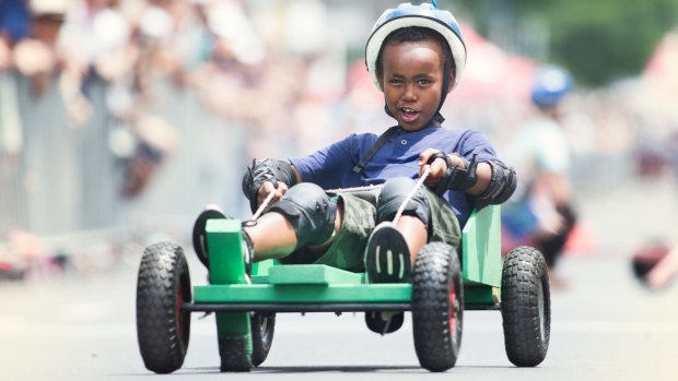 Imran Saney, 8, competing in the 2016 Kensington Australia Day Festival's children's billycart races down Macaulay Road.