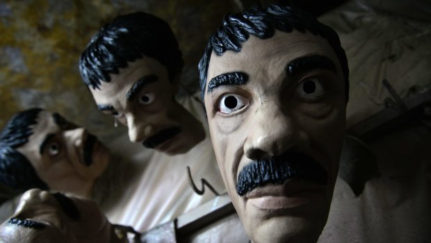 Latex masks depicting Mexican drug lord Joaquin "El Chapo" Guzman hang out to dry in the Caretas REV costume maker plant in Cuernavaca, Mexico. 