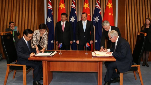 Chinese President Xi Jinping and then prime minister Tony Abbott witness the signing of the declaration of intent on the Australia/China Free Trade Agreement at Parliament House in Canberra.