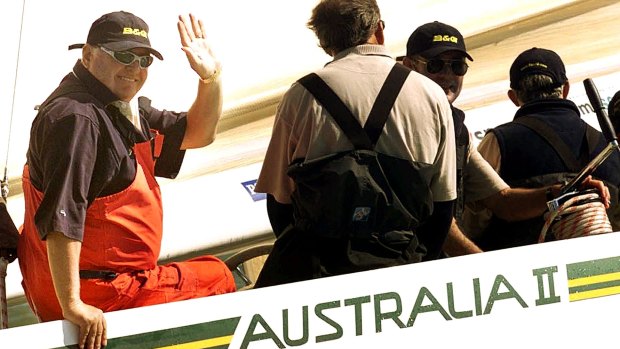 Australian entrepreneur Alan Bond waves from Australia II, during a race around the Isle of Wight, England in 2001 for the America's Cup Jubilee.