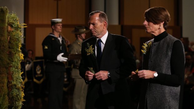 Prime Minister Tony Abbott and his wife Margie place a floral tribute on the wreath at the National Memorial Service for MH17 at Parliament House on Friday.