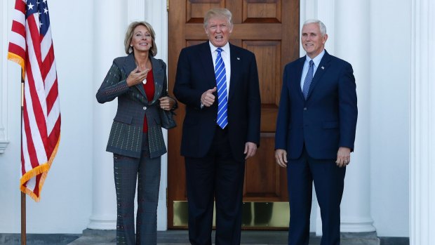 Betsy DeVos, Donald Trump and Mike Pence on Saturday.