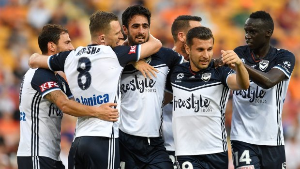 Winning ways: Melbourne Victory players celebrate a welcome return to form after overcoming an injury-hit Brisbane Roar.