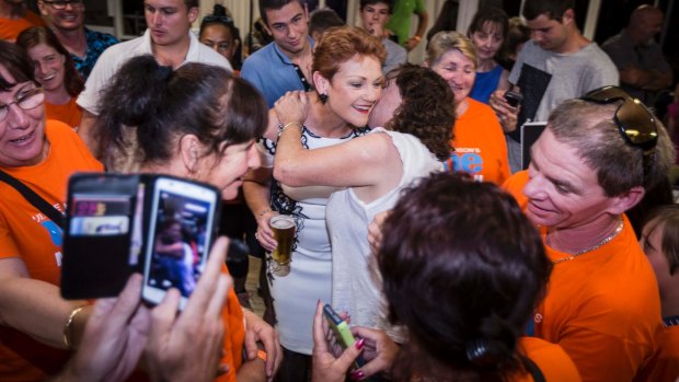Pauline Hanson is surrounded by supporters at the One Nation party.