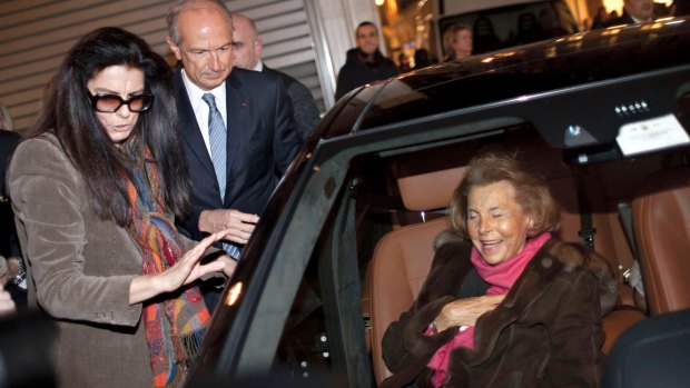 L'Oreal heiress Liliane Bettencourt, right, and her daughter Francoise Bettencourt-Meyers leaving the Armani spring/summer fashion collection, in Paris in 2011.