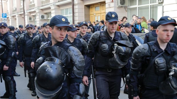 Security in authoritarian nations means also controlling the information space. Police officers cordon off a street at the presidential administration building during a protest in downtown Moscow, Russia.