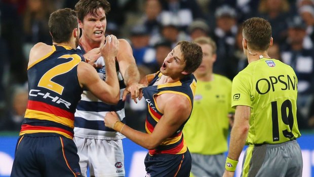 Cop that: The Crows' Matt Crouch reacts as brother Brad and 200-game Cat Tom Hawkins wrestle at Simonds Stadium on Friday night.