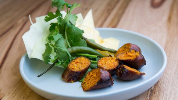 Fermented sausage comes with cabbage leaf, pineapple and pickled green chilli.