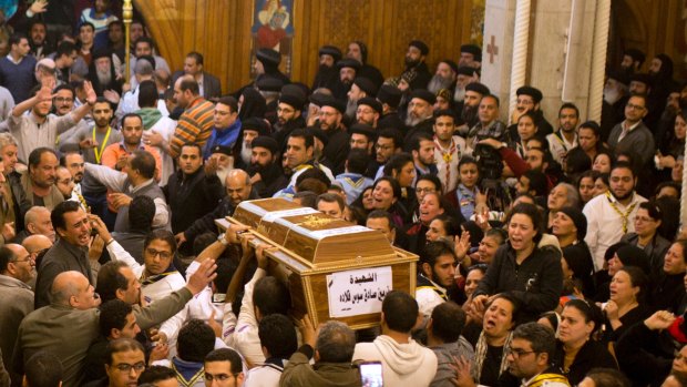 Relatives of Coptic Christians grieve as they carry the coffin of Nermin Sadek, one of the victims of the attack on the church known as Mar Mina near Cairo.