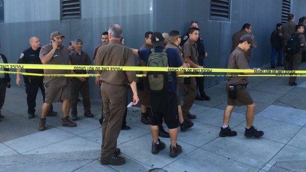 UPS workers gather outside after a shooting at warehouse in San Francisco.