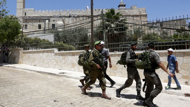 Israeli soldiers outside the site known to Muslims as the Ibrahimi Mosque and to Jews as the Cave of the Patriarchs.  