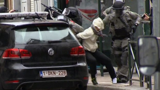 The moment Salah Abdeslam is bundled into a car by police.