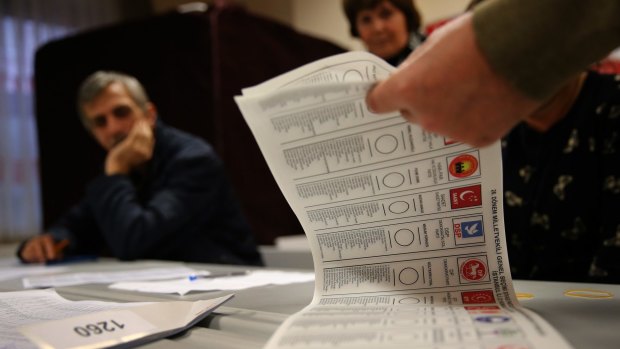 A Turkish election official counts ballots shortly after the polling stations closed on Sunday.