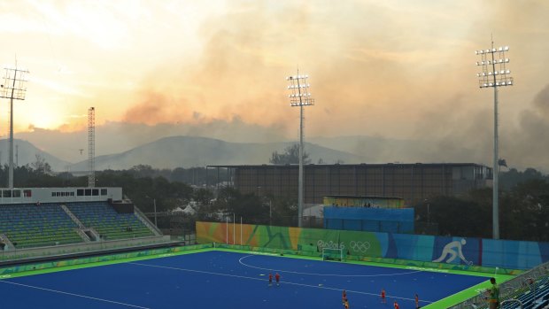 Smoke and ash blows over the hockey venue