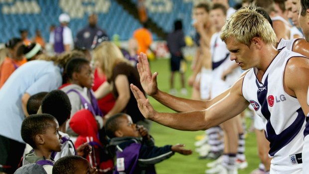 Byron Schammer of Fremantle high-fives a South African child in 2008.