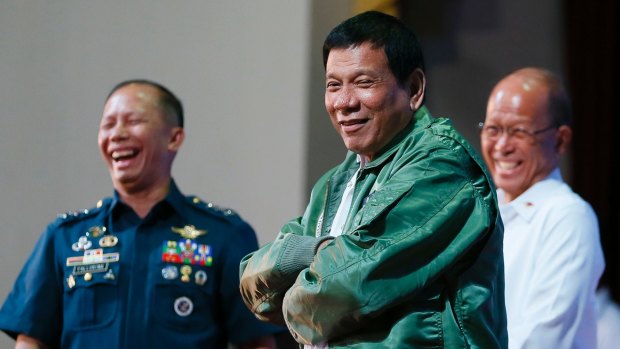 Philippine President Rodrigo Duterte wears a pilot's jacket presented to him during a visit to Air Force headquarters in Pasay, Philippines on Tuesday.