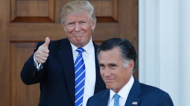 President-elect Donald Trump gives the thumbs-up as Mitt Romney leaves a meeting last month.
