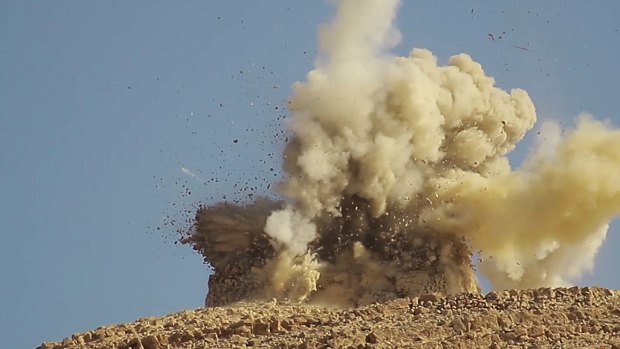 This undated photo shows one of two mausoleums being blown up by Islamic State militants in the historic central town of Palmyra, Syria.