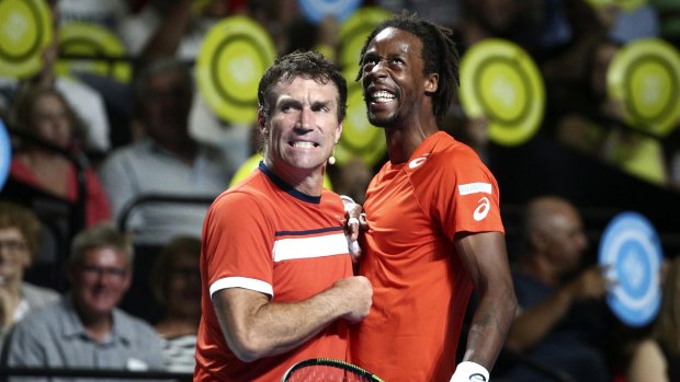 Light-hearted fun: Pat Cash and Gael Monfils share a moment.