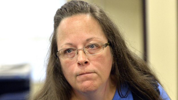 Rowan County Clerk Kim Davis listens to a customer following her office's refusal to issue marriage licences at the Rowan County Courthouse in Morehead, Kentucky.